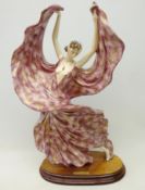 Art Deco style figure of a dancing woman, by Santini on oval plinth,