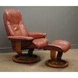 Stressless reclining armchair and stool, upholstered in maroon leather,