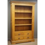 Light oak bookcase, fielded panelled back and sides, three shelves above four drawers,