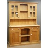 Pine dresser, projecting cornice, two shelves, flanked by two glazed cupboards,