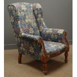 Victorian wingback armchair, upholstered in floral pattern fabric,