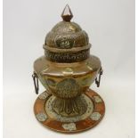 Indian copper urn shaped jar and cover decorated with repousse panels depicting deities,
