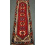 Turkish red ground runner rug with repeating geometric motif,