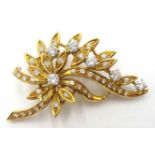 18ct gold diamond floral brooch, six principle diamonds and diamond set leaves stamped 750, 4.