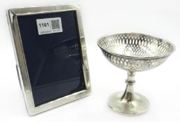 Silver pedestal bon-bon basket, weighted ht 10cm and a photograph frame ht 15cm both hallmarked