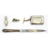 Silver vesta, napkin clip, rattle and silver handled paper knife