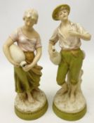 Pair of Royal Dux figures, depicting water carriers on circular base, pink triangle mark to base,