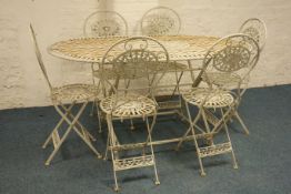 Cast metal oval garden table and a set of six folding garden chairs (7)