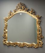 Ornate gilt scroll framed arched mirror, W112cm,