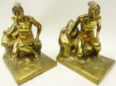 Pair gilt spelter bookends in the form of a Native American seated on a rock base,