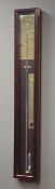 Contemporary mercury barometer in mahogany case enclosed by glazed door, with thermometer,