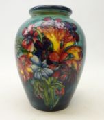 Moorcroft 'Spring Flowers' baluster shaped vase on blue ground,