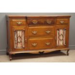 Edwardian walnut side board, five drawers, two glazed cupboard doors, carved and shaped apron,
