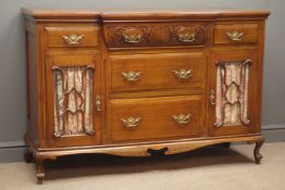 Edwardian walnut side board, five drawers, two glazed cupboard doors, carved and shaped apron,