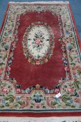 Chinese beige gorund rug, central medallion with red field and border,