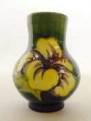 Moorcroft 'Hibiscus' pattern vase on green ground, H13.