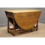 Early 20th century oak oval drop leaf gate action table, single drawer,