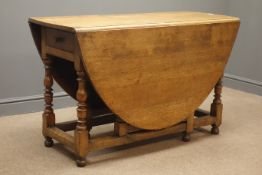 Early 20th century oak oval drop leaf gate action table, single drawer,