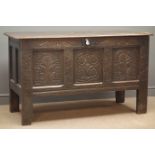 Early 19th century panelled oak blanket box, hinged lid with clasp, heavily carved, stile supports,