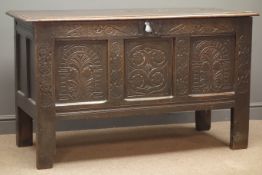 Early 19th century panelled oak blanket box, hinged lid with clasp, heavily carved, stile supports,