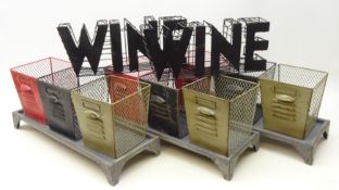 Three sets of three wire work storage baskets on oblong stand,