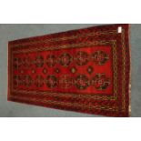 Antique Persian Bokhara red ground rug,