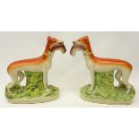 Pair of Victorian flat back Staffordshire greyhounds,holding rabbits in their mouths,