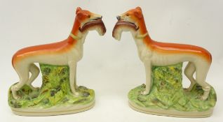 Pair of Victorian flat back Staffordshire greyhounds,holding rabbits in their mouths,