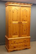 Pine double wardrobe, projecting cornice, panelled doors, fitted interior above two drawers,