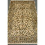 Persian Kashan beige ground rug with floral and foliate field,