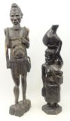 Pair large African carved lignum vitae figures of a man and woman,