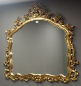 Ornate arched gilt framed wall mirror, W120cm,