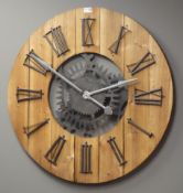 Large circular planked pine wall clock with Roman numerals,