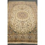 Fine Persian Nain beige ground rug, central medallion, floral field, repeating border,