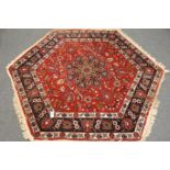 Persian design octagonal red ground rug,