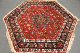 Persian design octagonal red ground rug,