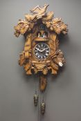 Large 'Kaiser' Black Forest type cuckoo clock, case carved with birds nest and leaves,