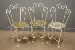 Three wrought metal garden chairs,