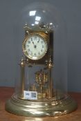 Late 19th century brass anniversary clock, under glass dome,