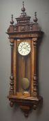 Large Vienna walnut cased wall clock, triple finial pediment, circular Roman dial,