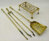 Set of brass fire irons and a brass trivet on four claw feet,