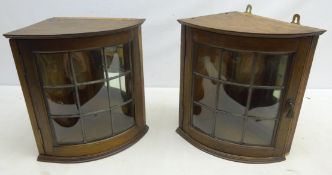 Two Arts & Crafts style oak corner cupboards with leaded glass doors and mirrored back,