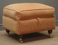 Upholstered footstool, hinged lid, upholstered in red and gold fabric, turned supports on castors,