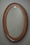 Edwardian oak inlaid oval mirror, W61cm,