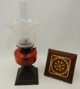 Victorian oil lamp with pierced cast metal base, ruby glass well and glass shade,