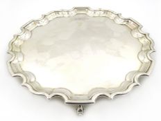 Silver waiter with pie crust border and three scroll feet by Carr's of Sheffield Ltd,