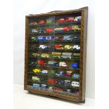 Stained wooden wall mounting die-cast display cabinet with carved frame and pair of sliding glass