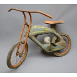 Child's red painted tubular framed bicycle in the form of a motor cycle with moulded metal petrol