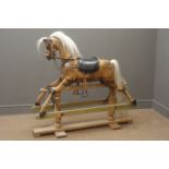 Victorian style wooden rocking horse with stained and dappled carved sectional body,