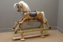 Victorian style wooden rocking horse with stained and dappled carved sectional body,